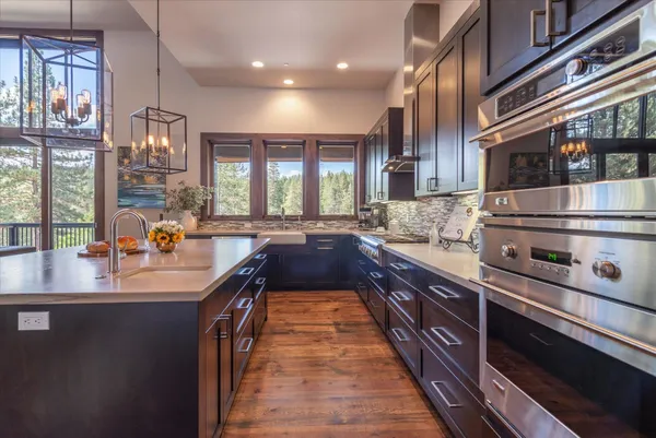 a bedroom with a large bed and wooden floor