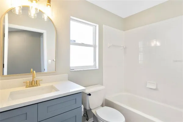 a bathroom with a sink toilet tub and shower