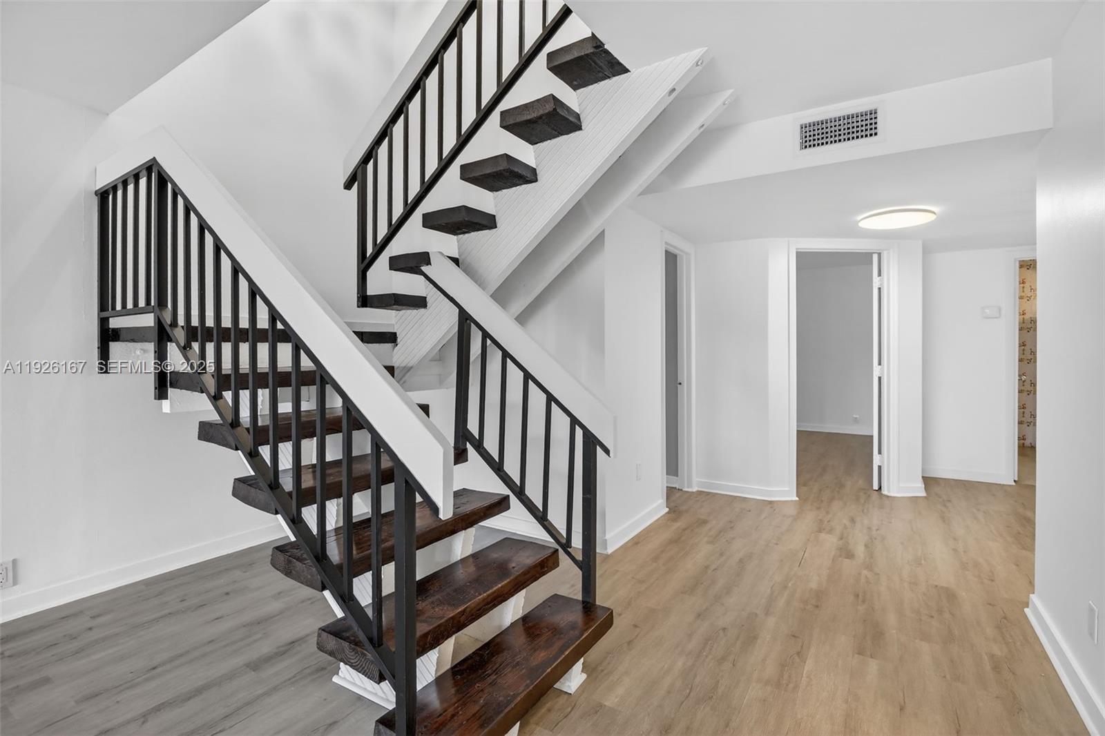 9703 North New River Canal Road, Unit 103 Plantation, FL 33324 - Photo 17 of 32 a view of staircase with wooden floor and white walls