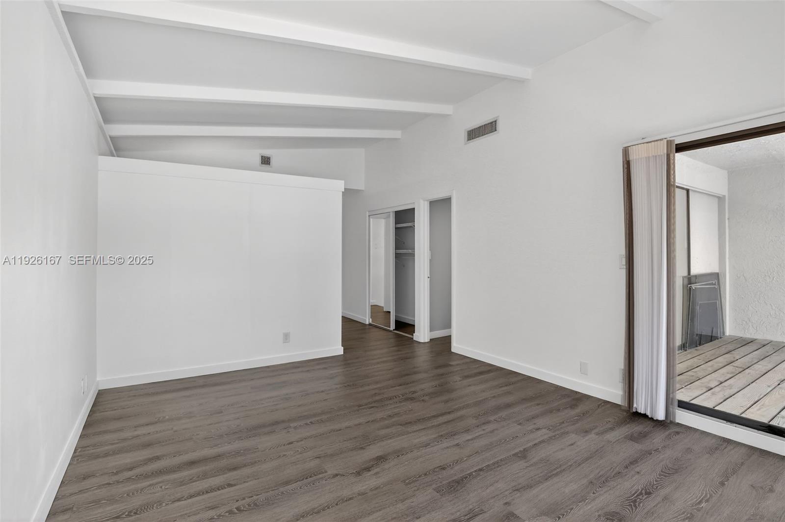 9703 North New River Canal Road, Unit 103 Plantation, FL 33324 - Photo 19 of 32 a view of an empty room with wooden floor and a window