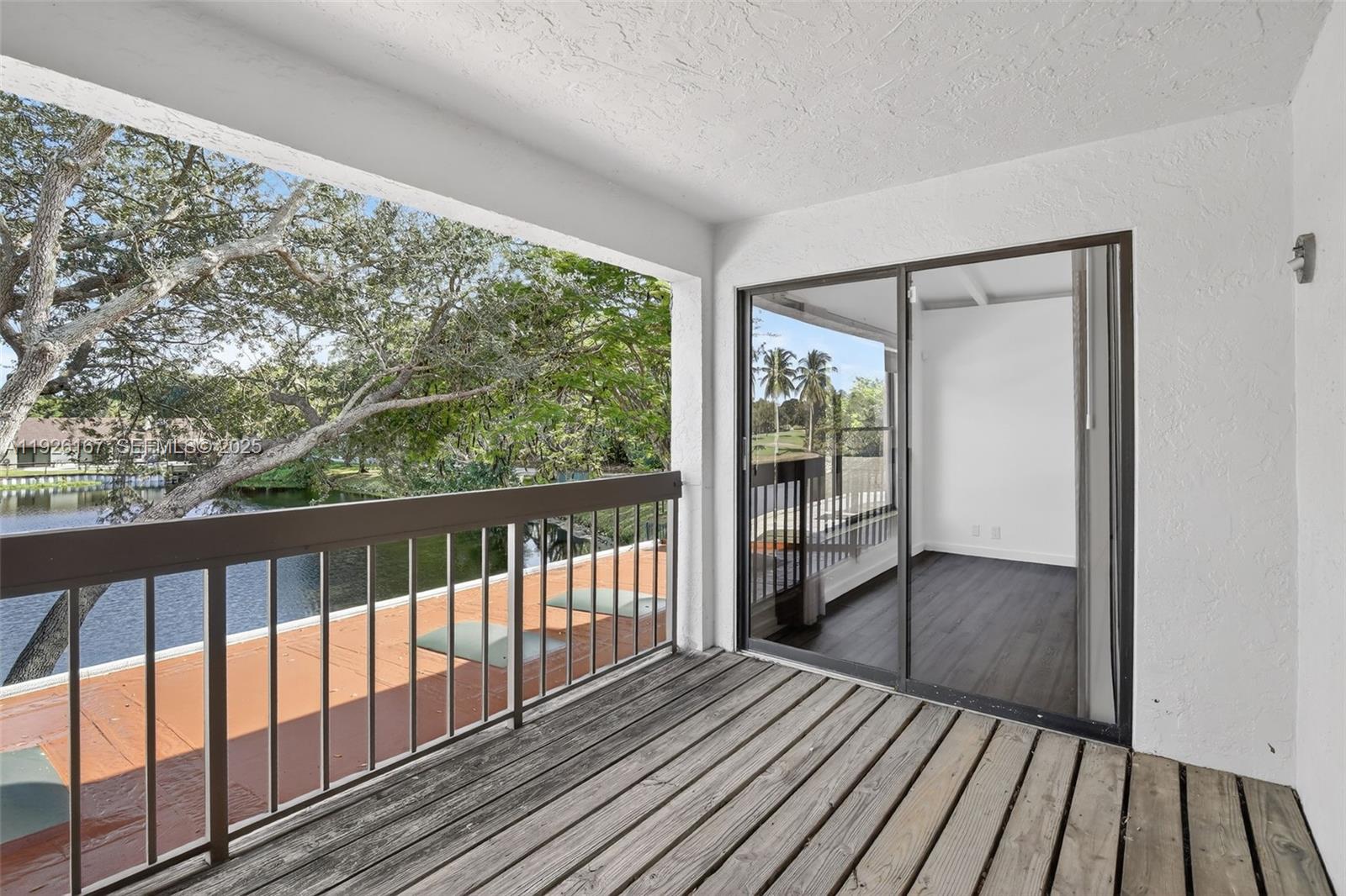 9703 North New River Canal Road, Unit 103 Plantation, FL 33324 - Photo 21 of 32 a view of a balcony with wooden floor