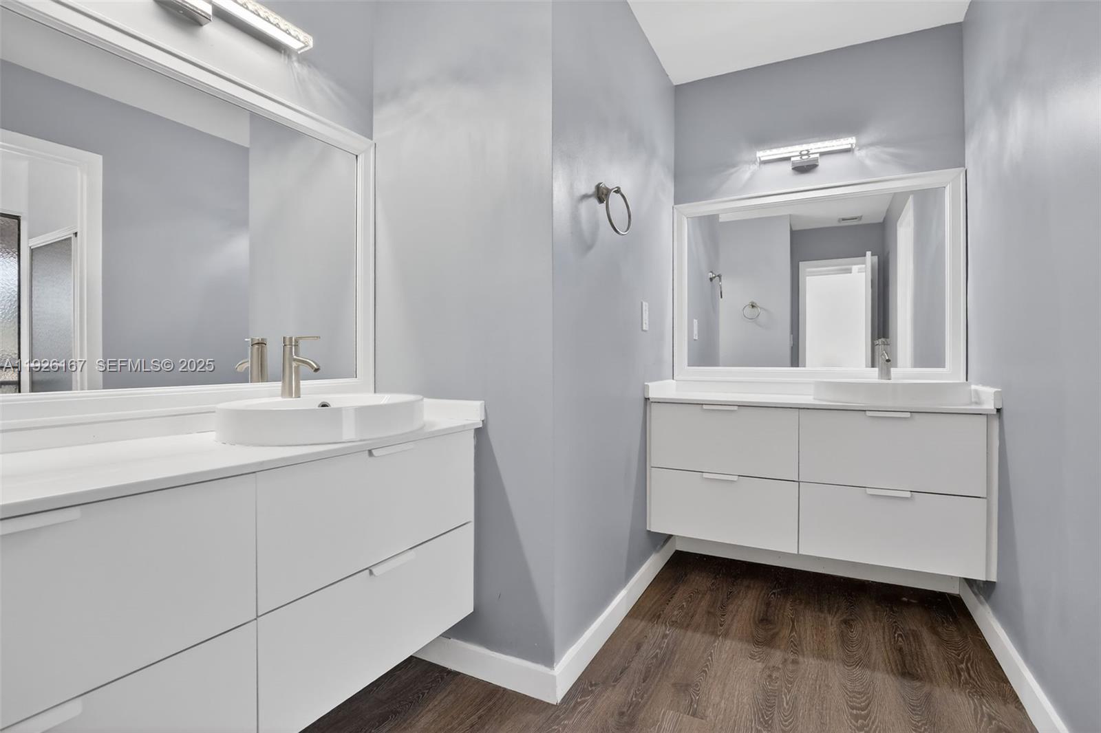 9703 North New River Canal Road, Unit 103 Plantation, FL 33324 - Photo 23 of 32 a bathroom with a sink vanity and mirror