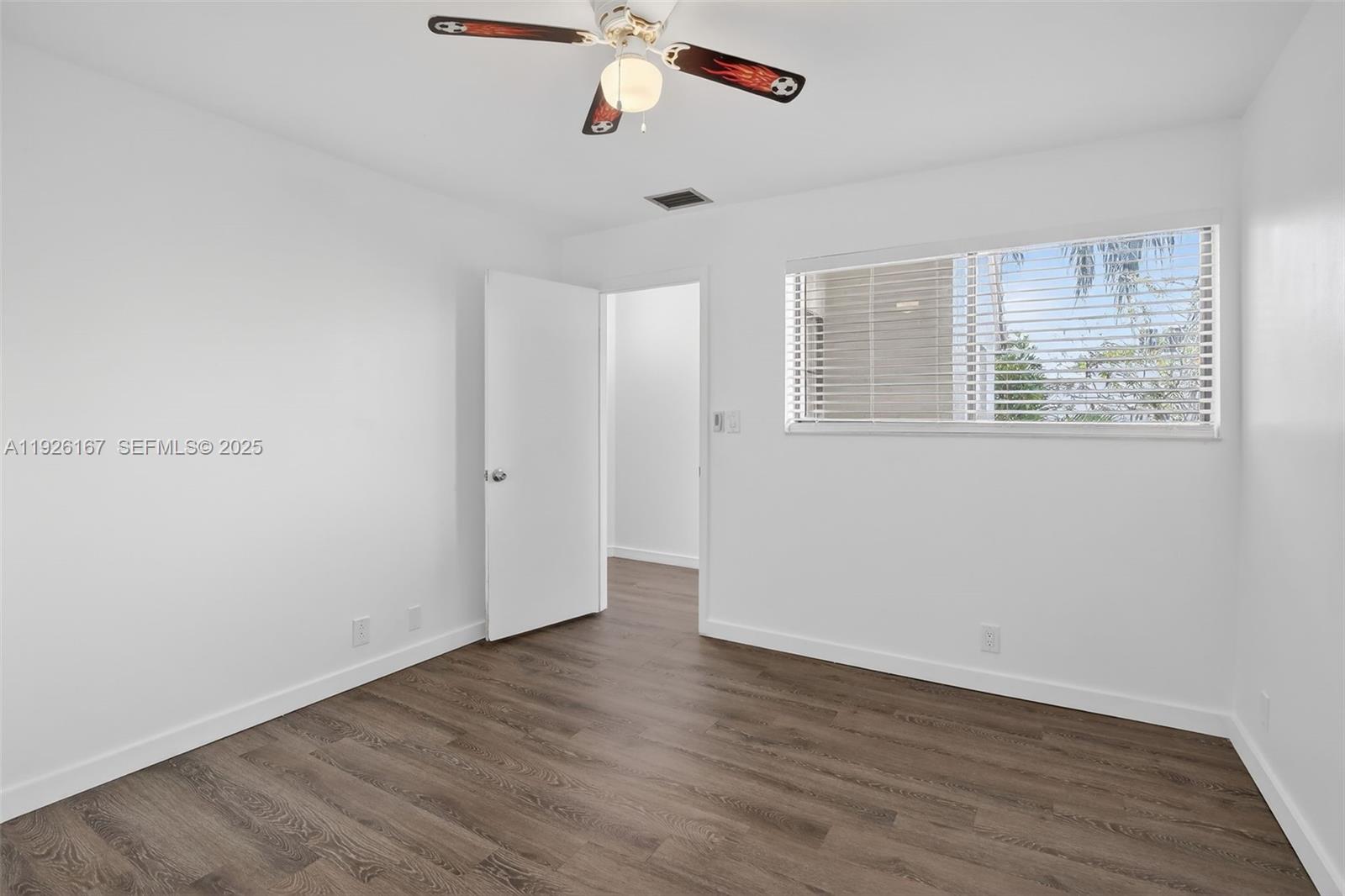 9703 North New River Canal Road, Unit 103 Plantation, FL 33324 - Photo 26 of 32 an empty room with wooden floor and windows