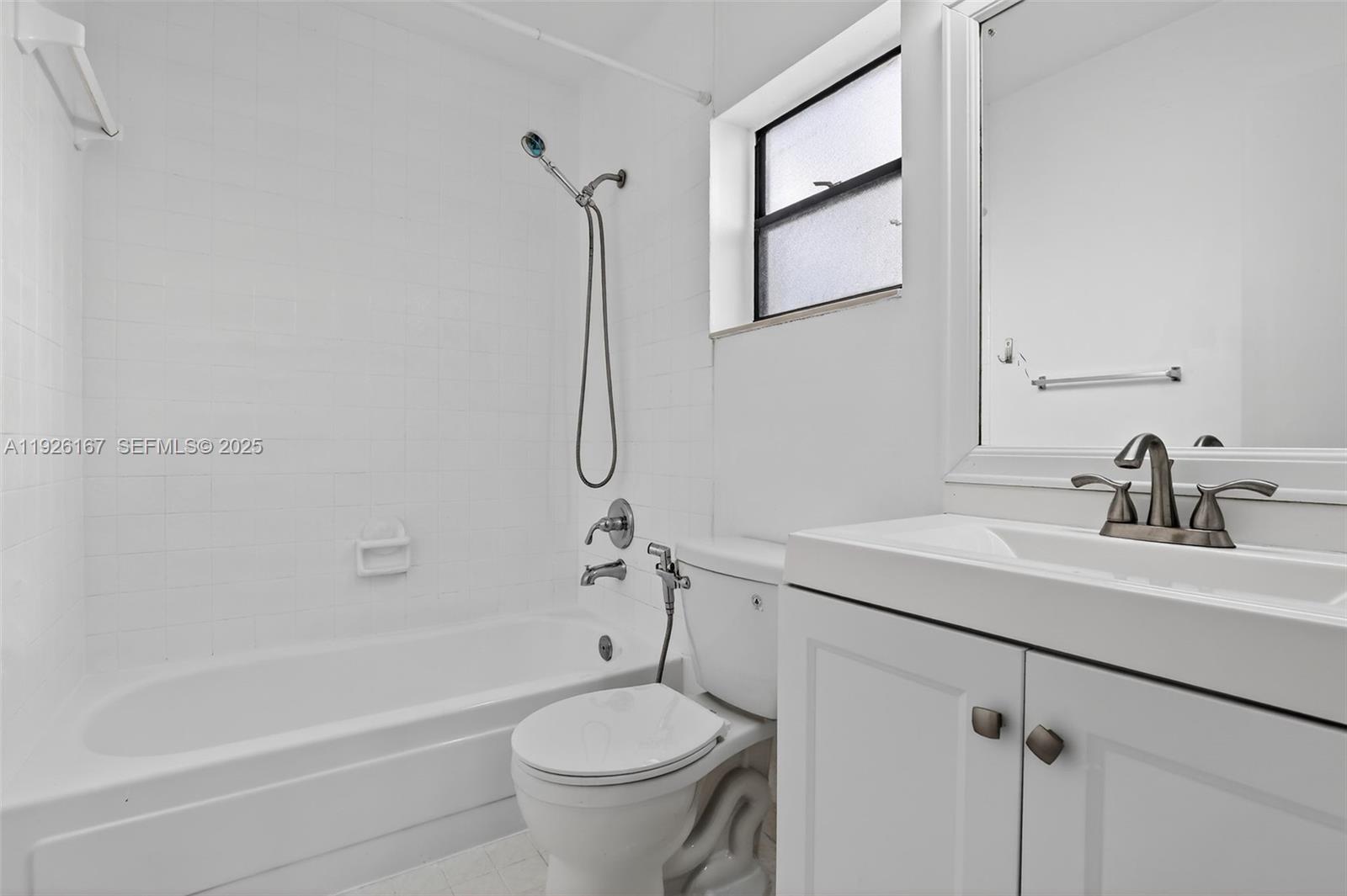 9703 North New River Canal Road, Unit 103 Plantation, FL 33324 - Photo 27 of 32 a bathroom with a sink a toilet and a bathtub