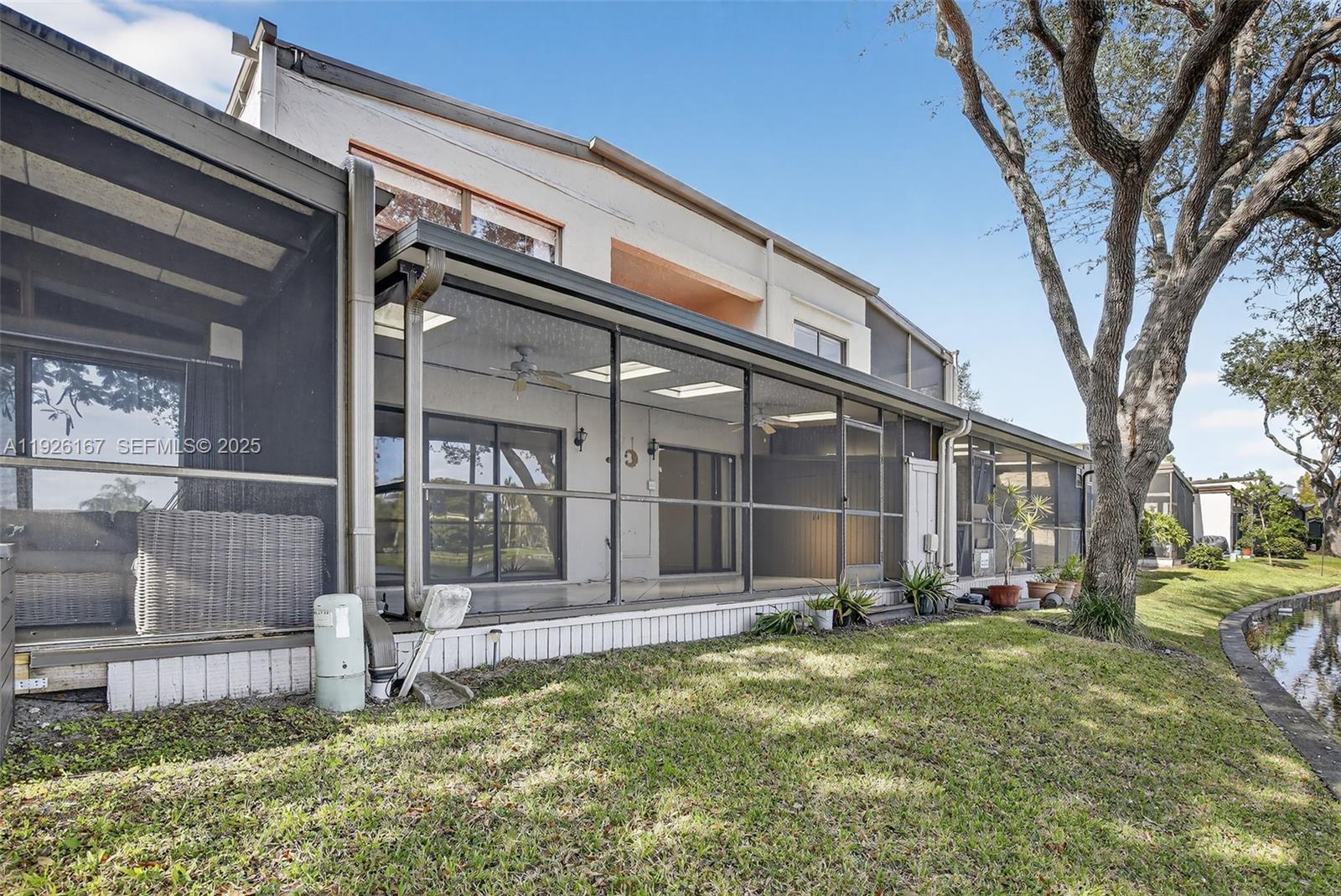9703 North New River Canal Road, Unit 103 Plantation, FL 33324 - Photo 28 of 32 a backyard of a house with lots of green space