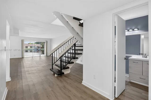 a view of entryway and hall with wooden floor