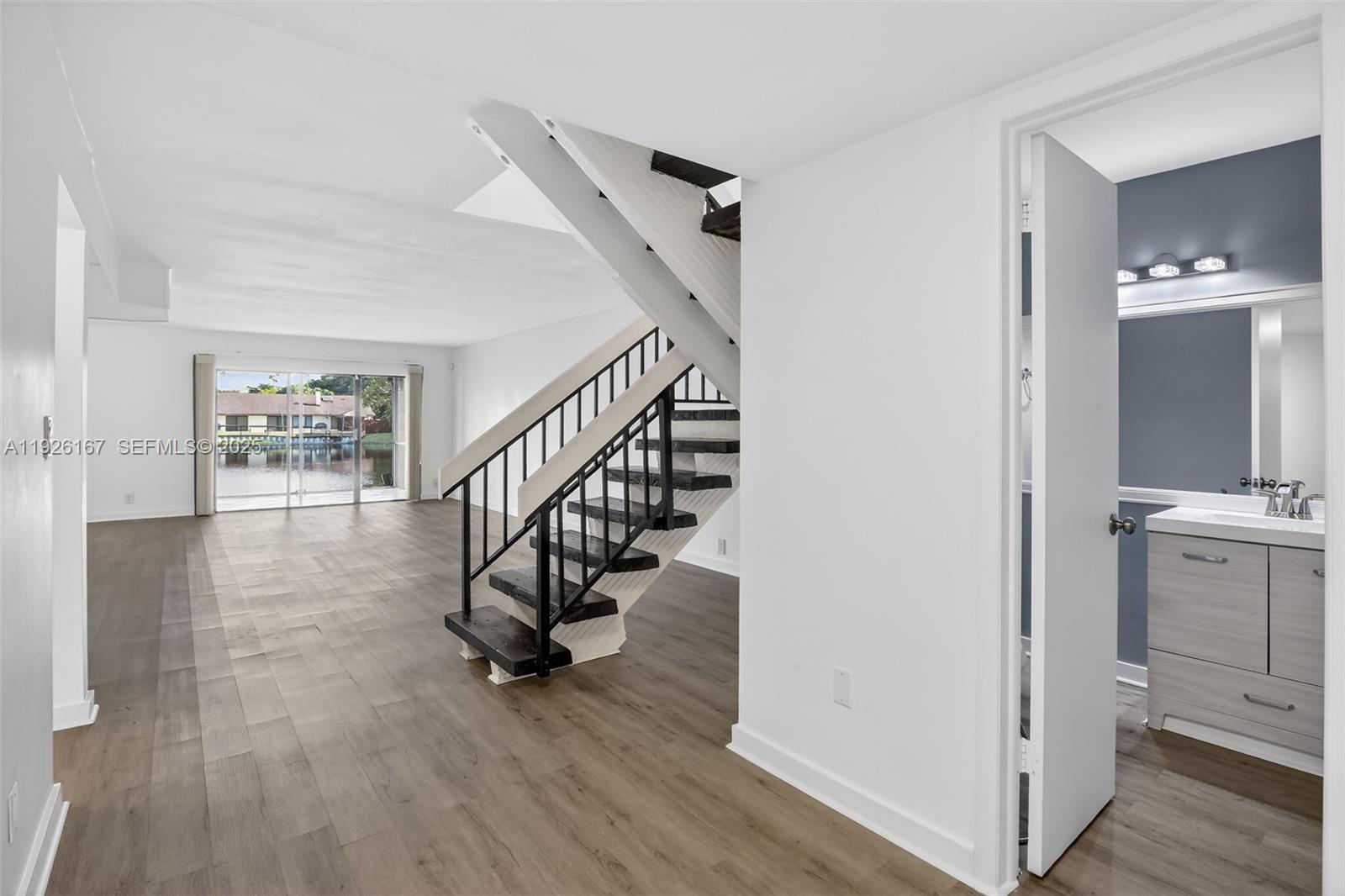 9703 North New River Canal Road, Unit 103 Plantation, FL 33324 - Photo 3 of 32 a view of entryway and hall with wooden floor