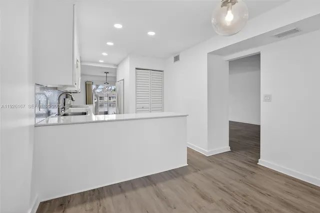 a room with wooden floor and window