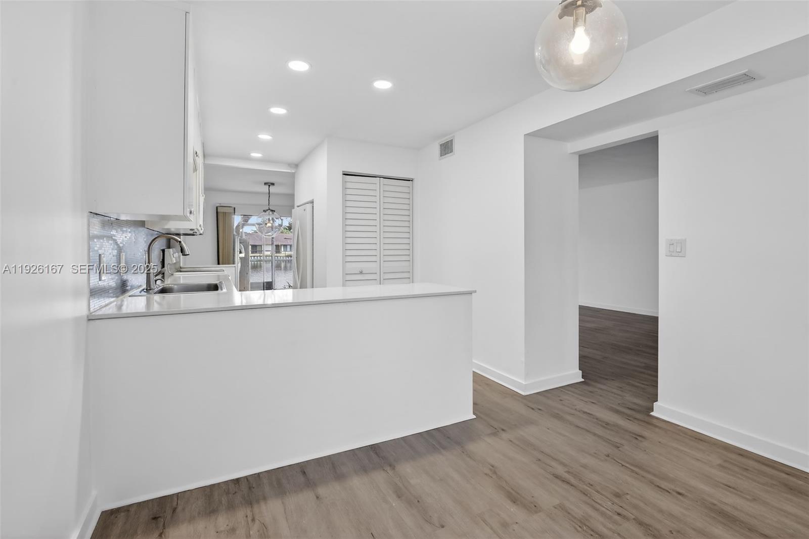 9703 North New River Canal Road, Unit 103 Plantation, FL 33324 - Photo 5 of 32 a room with wooden floor and window