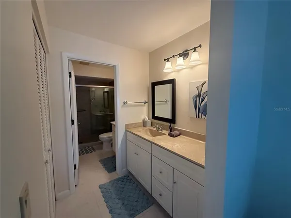 a spacious bathroom with a double vanity sink and a mirror