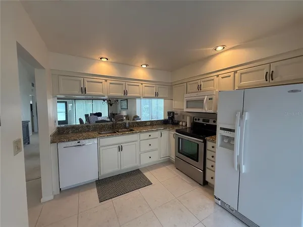 a kitchen with stainless steel appliances granite countertop a sink and cabinets