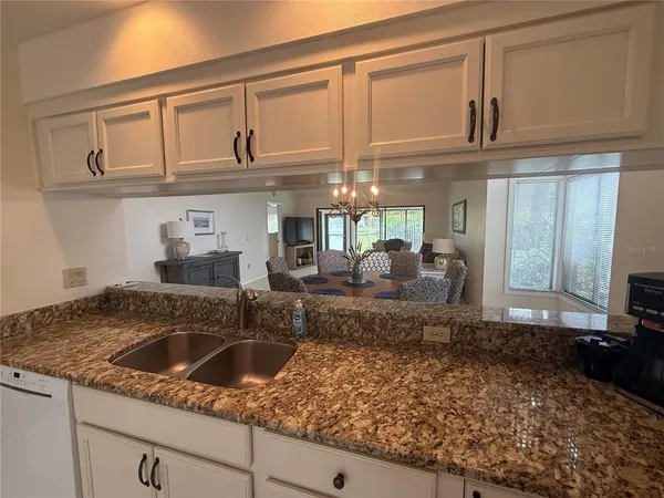 a kitchen with stainless steel appliances granite countertop a sink and cabinets
