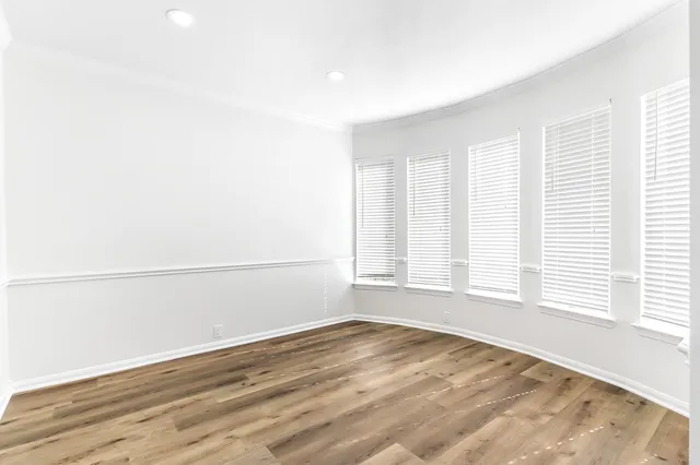 a view of a room with wooden floor and a window