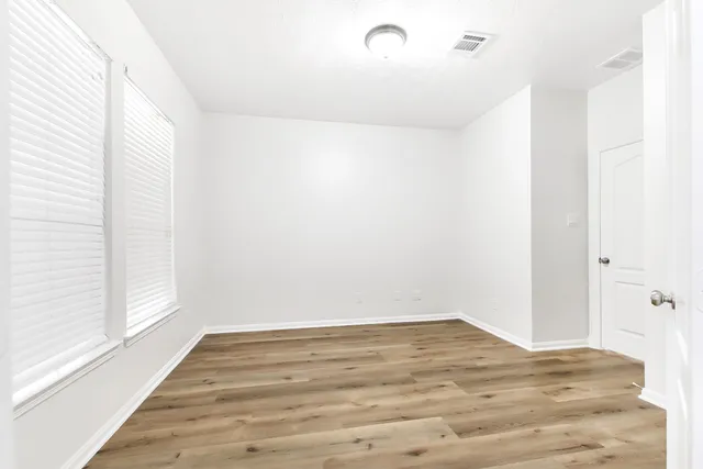 a bathroom with a double vanity sink a mirror and a bathtub