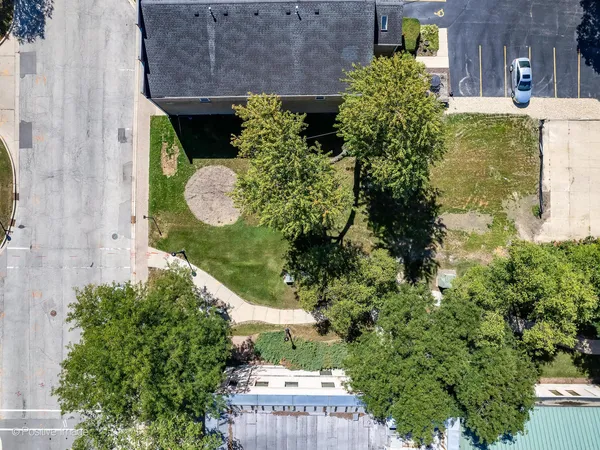 an aerial view of a house with a yard and garden