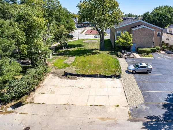 a view of backyard with outdoor seating and green space
