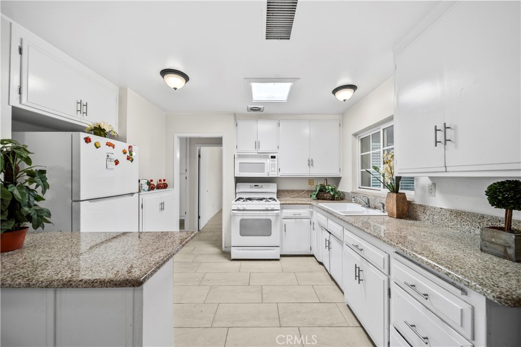 820 South Alessandro Street Hemet, CA 92543 - Photo 1 of 37 a kitchen with granite countertop a sink stainless steel appliances and white cabinets