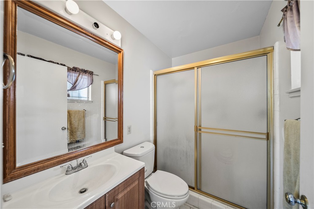 820 South Alessandro Street Hemet, CA 92543 - Photo 17 of 37 a bathroom with a sink mirror vanity and toilet