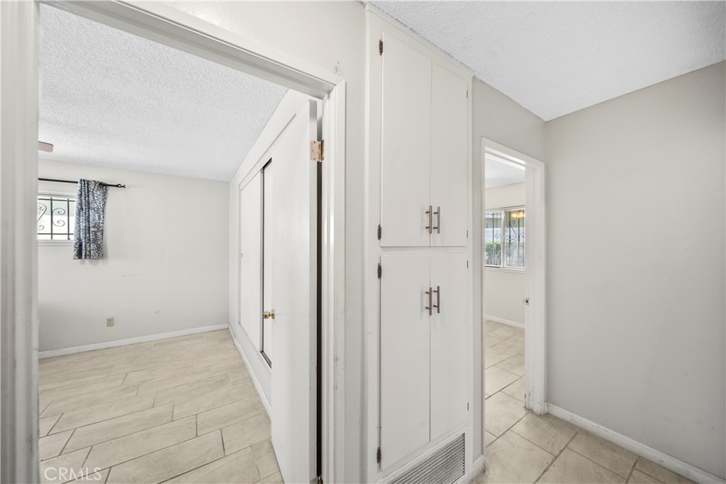 820 South Alessandro Street Hemet, CA 92543 - Photo 19 of 37 a view of a hallway with wooden floor and closet area