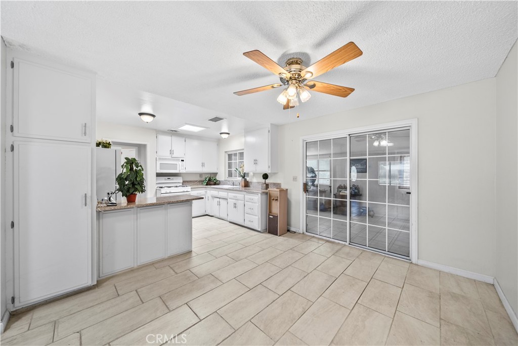 820 South Alessandro Street Hemet, CA 92543 - Photo 20 of 37 a view of a kitchen with cabinets and wooden floor
