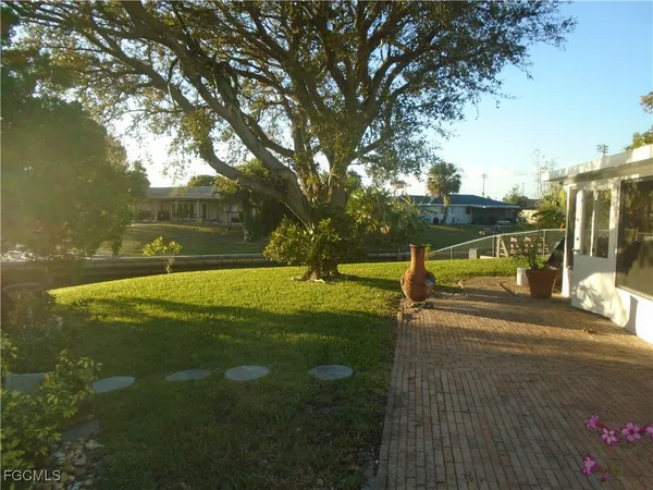 a view of yard with swimming pool and trees