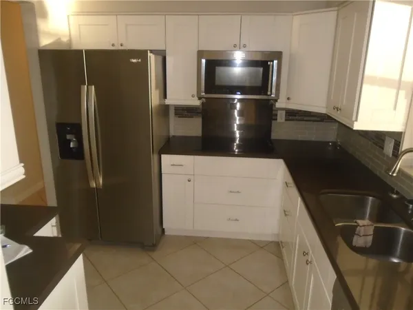 a kitchen with a refrigerator and a counter