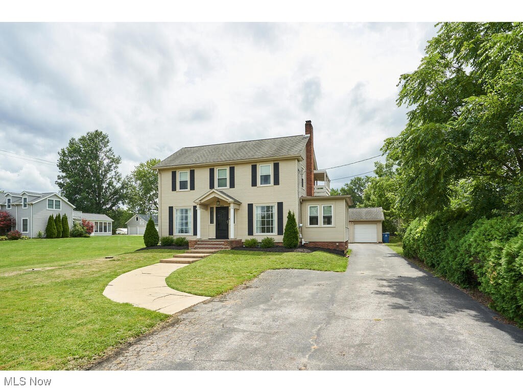 3468 Copley Road Akron, OH 44321 - Photo 1 of 22 Colonial inspired home with an outdoor structure, a front lawn, and a garage