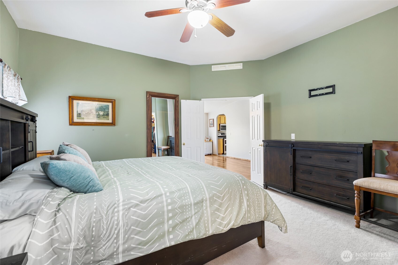 12455 Dodson Road Northwest Ephrata, WA 98823 - Photo 12 of 40 a bedroom with a bed and a chandelier