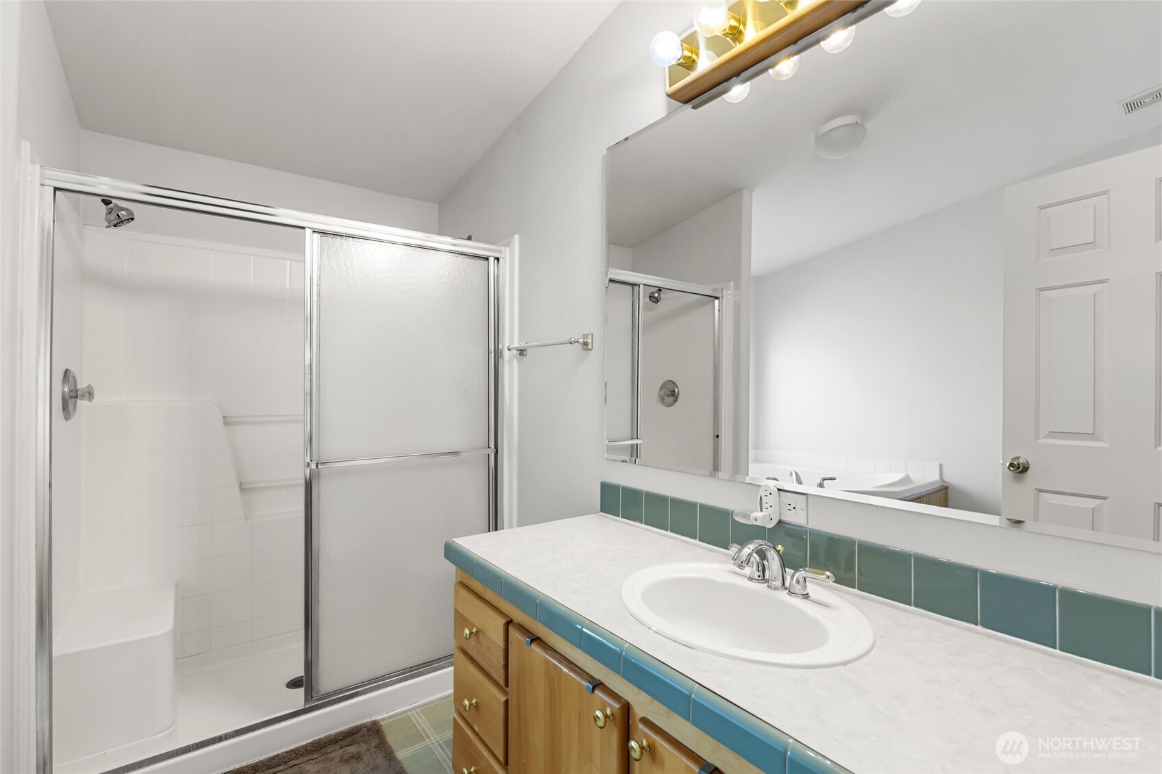 12455 Dodson Road Northwest Ephrata, WA 98823 - Photo 13 of 40 a bathroom with a sink mirror and shower