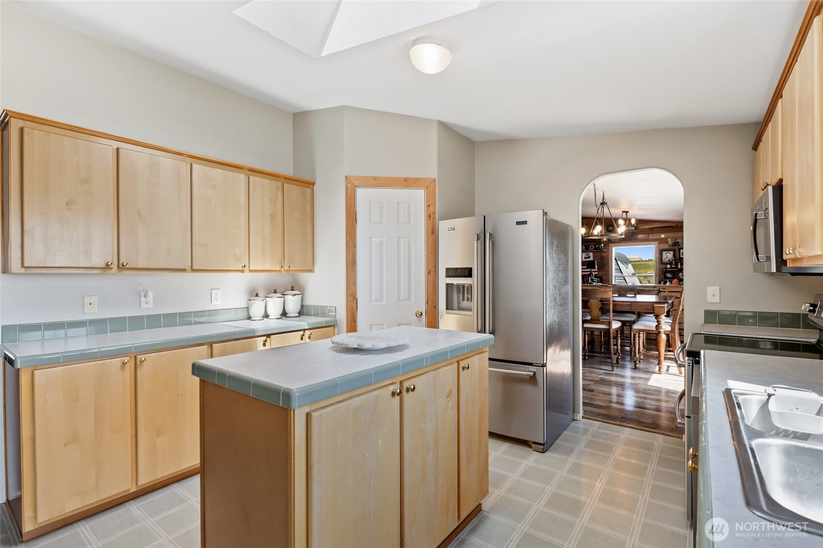 12455 Dodson Road Northwest Ephrata, WA 98823 - Photo 8 of 40 a kitchen that has a lot of white cabinets and stainless steel appliances