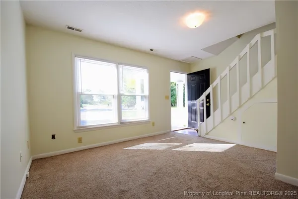 a kitchen with granite countertop a refrigerator a stove a sink dishwasher and a dining table with wooden floor