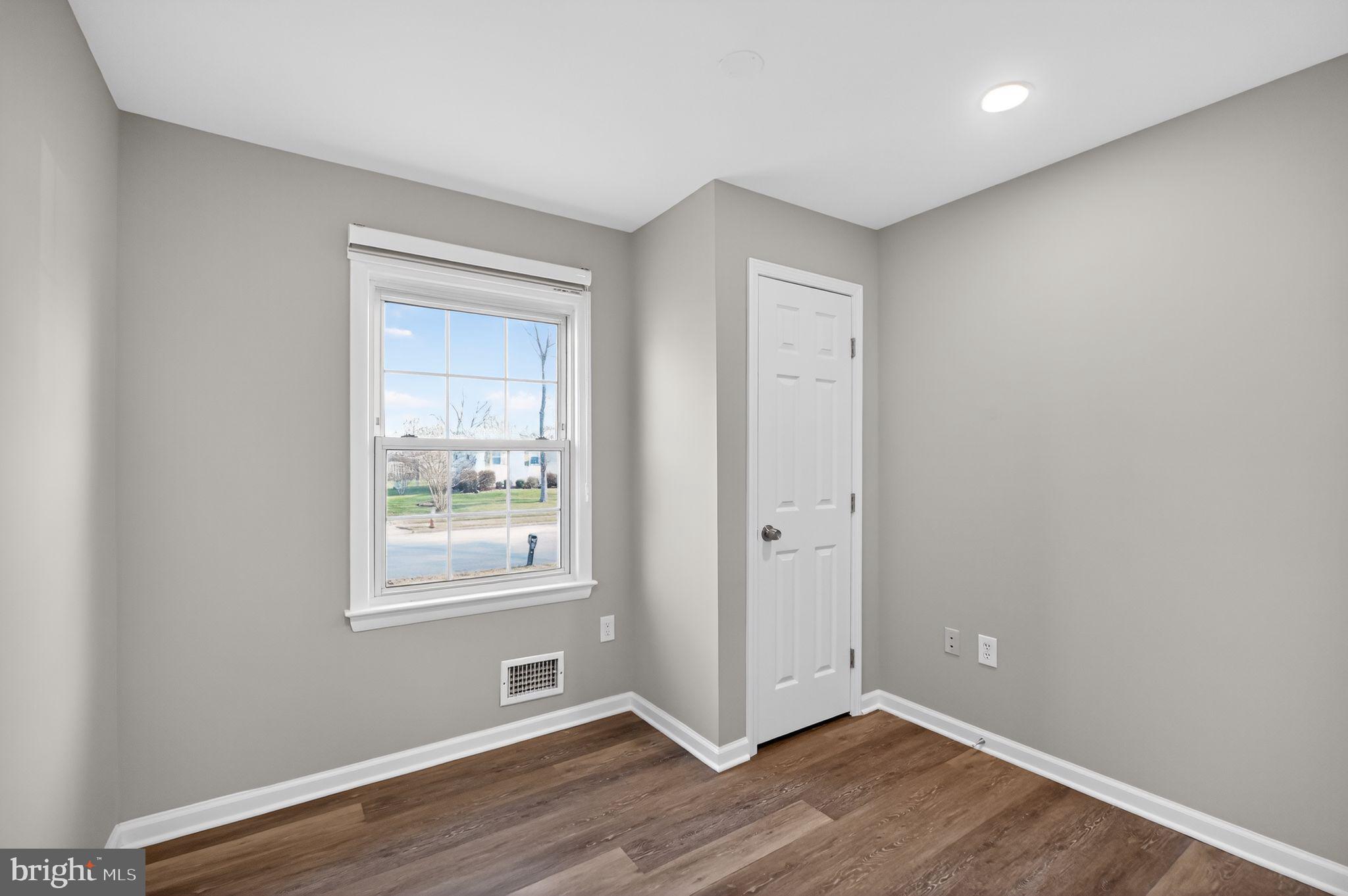 8012 Frye Road Alexandria, VA 22309 - Photo 18 of 40 an empty room with wooden floor and windows