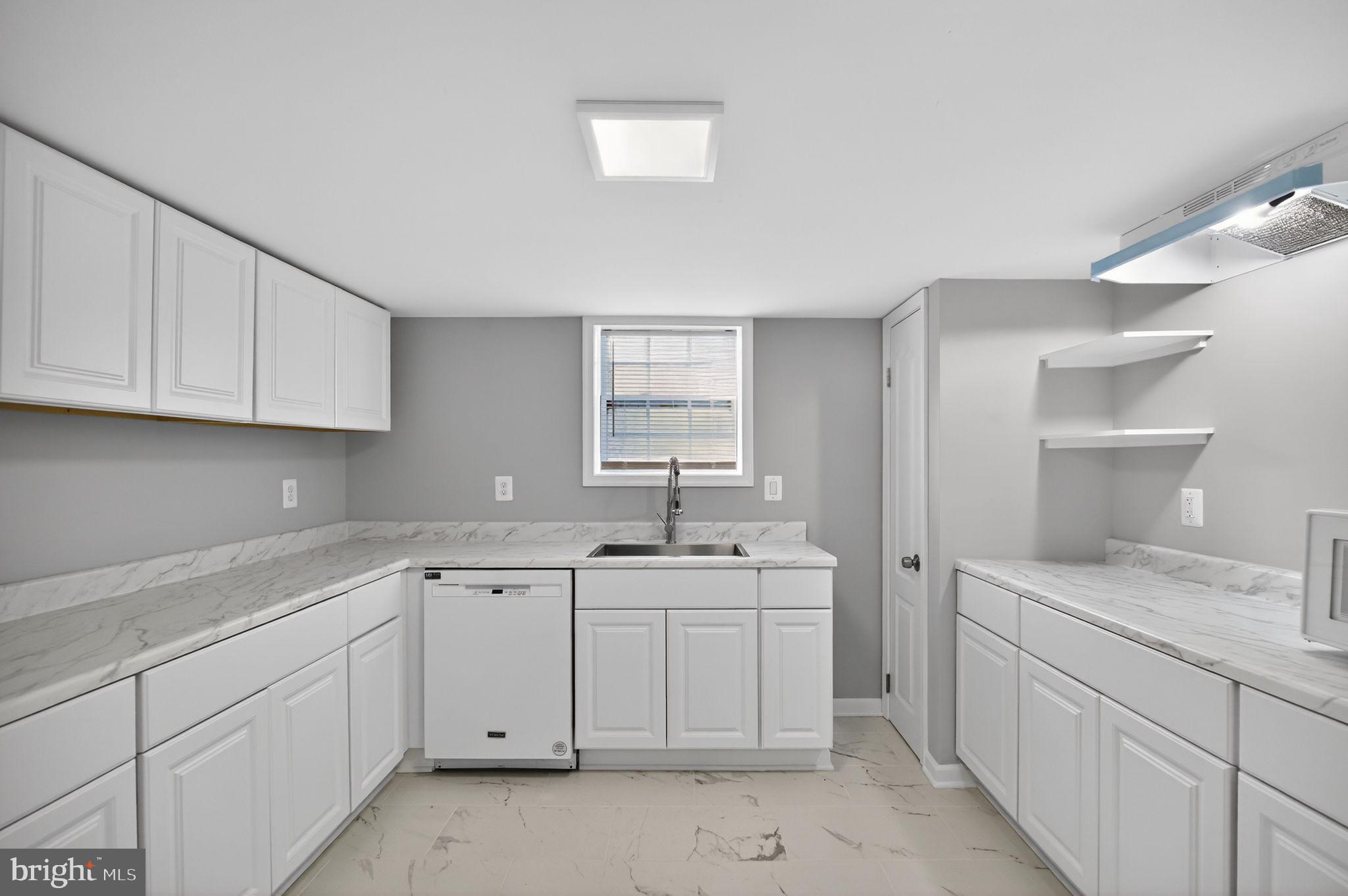 8012 Frye Road Alexandria, VA 22309 - Photo 31 of 40 a kitchen with a sink dishwasher and cabinets