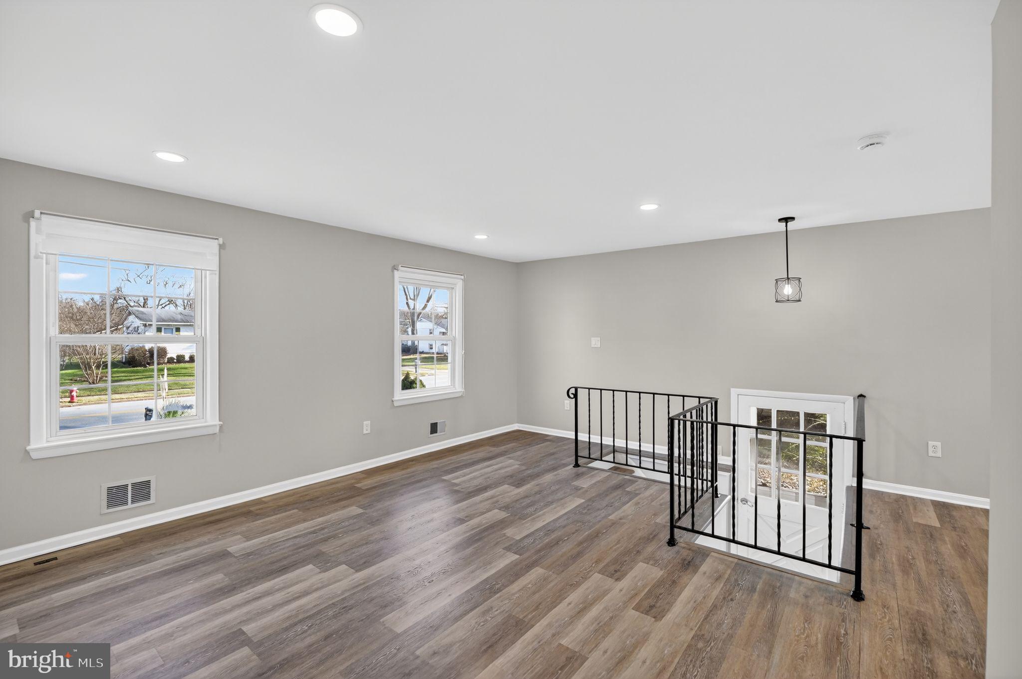 8012 Frye Road Alexandria, VA 22309 - Photo 8 of 40 a view of an empty room with wooden floor and a window