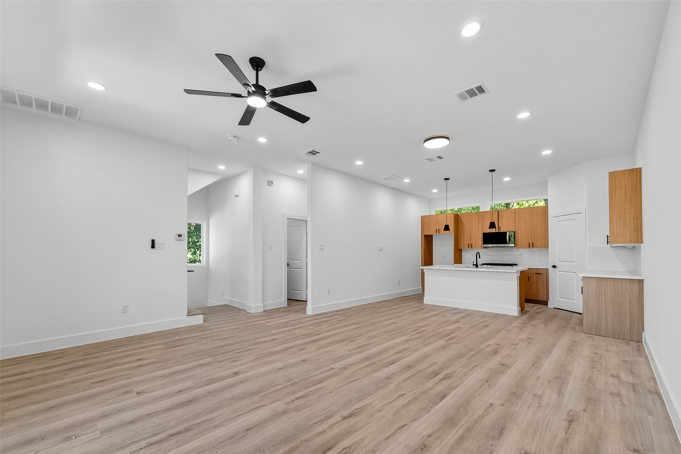 3315 Nettleton Street Houston, TX 77004 - Photo 14 of 38 a view of a kitchen with wooden floor and a ceiling fan