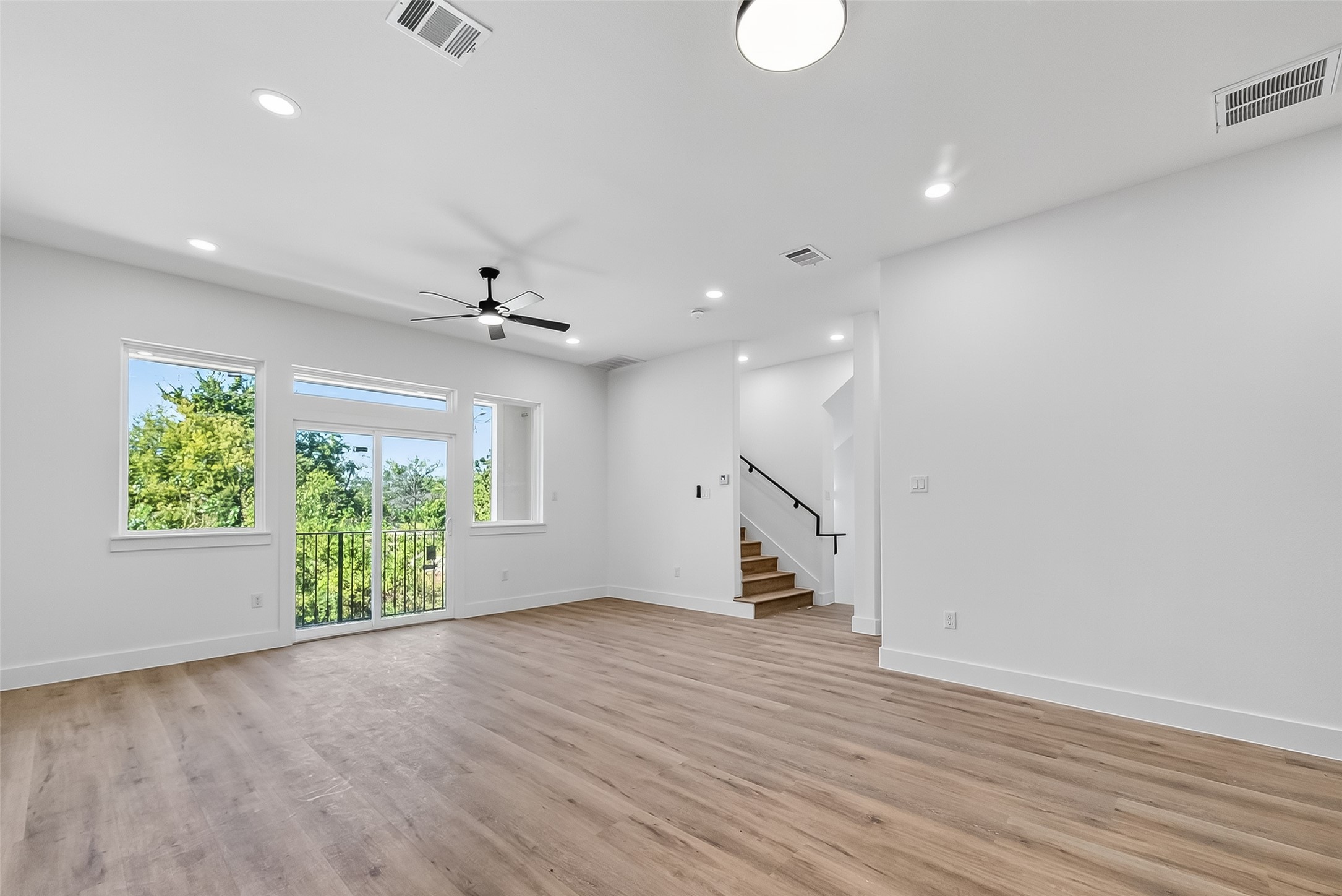 3315 Nettleton Street Houston, TX 77004 - Photo 7 of 38 an empty room with wooden floor gym equipment and windows