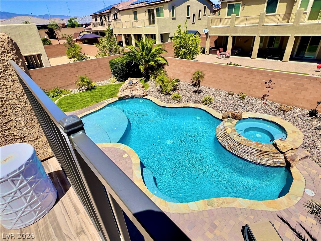 9724 University Ridge Avenue Las Vegas, NV 89149 - Photo 38 of 61 An inviting backyard oasis offers a free-form pool and integrated spa, surrounded by thoughtful landscaping.