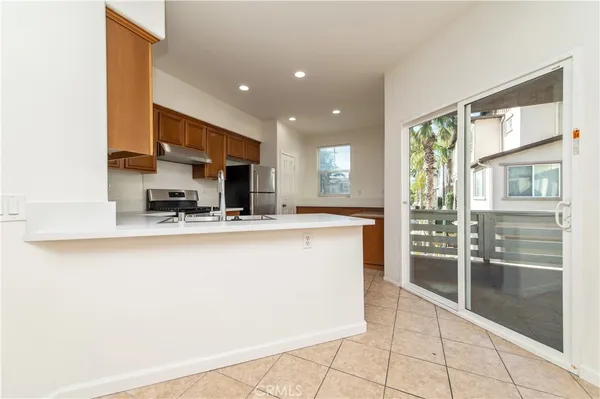 a kitchen with stainless steel appliances a refrigerator and a sink