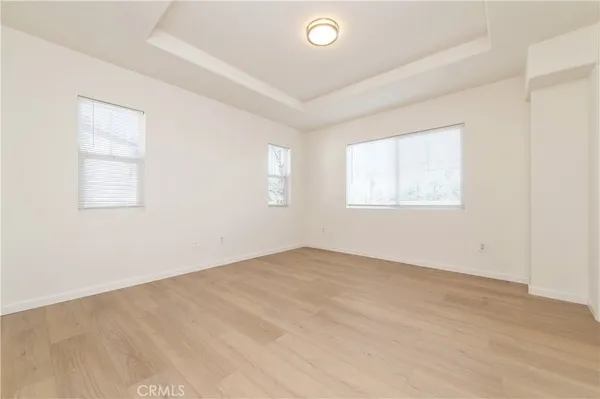 a view of an empty room with wooden floor