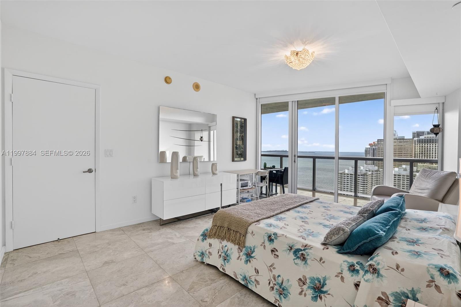 495 Brickell Avenue, Unit 2807 Miami, FL 33131 - Photo 12 of 23 a bedroom with a bed and a large window