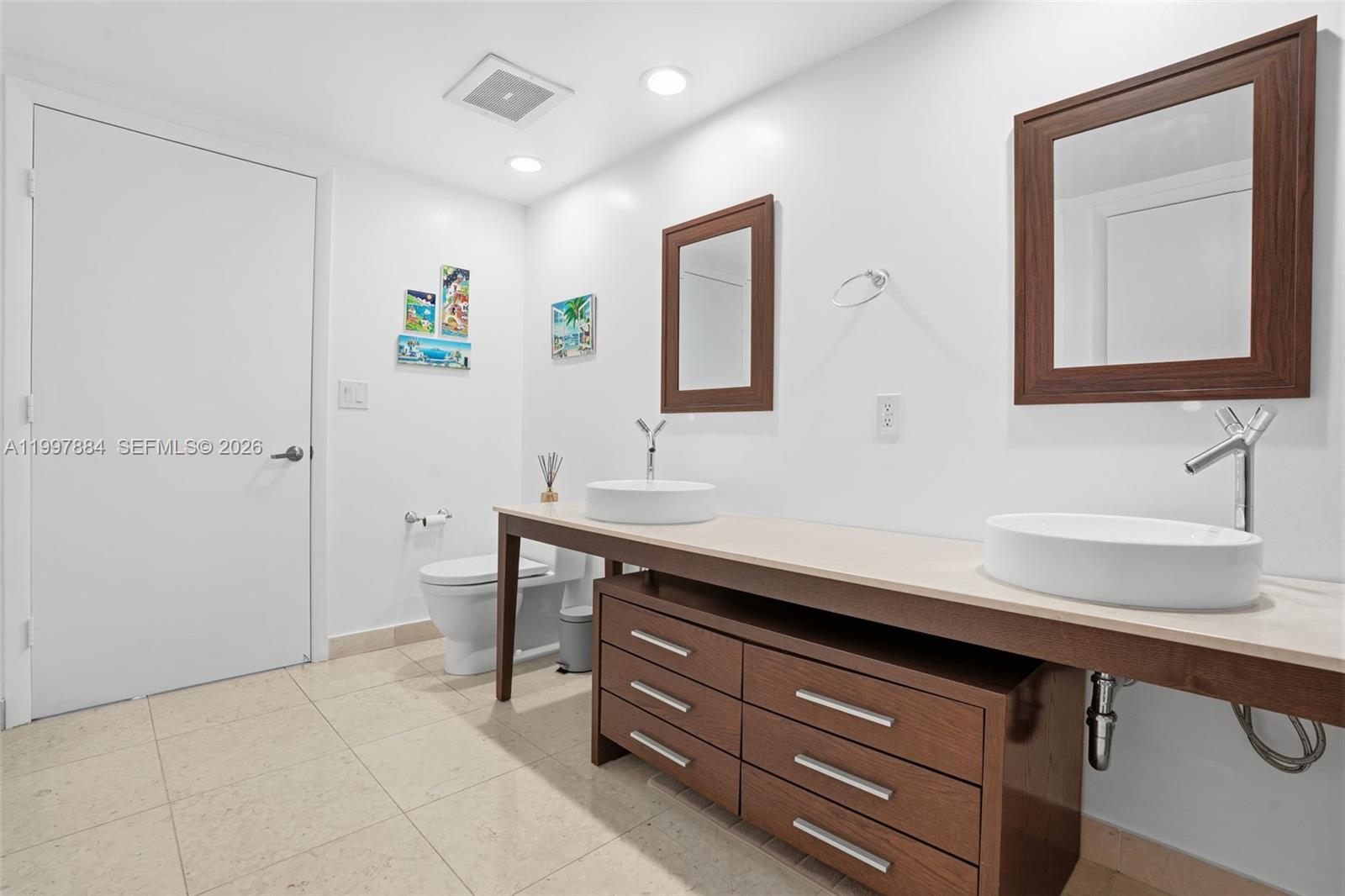 495 Brickell Avenue, Unit 2807 Miami, FL 33131 - Photo 18 of 23 a bathroom with a sink and a mirror