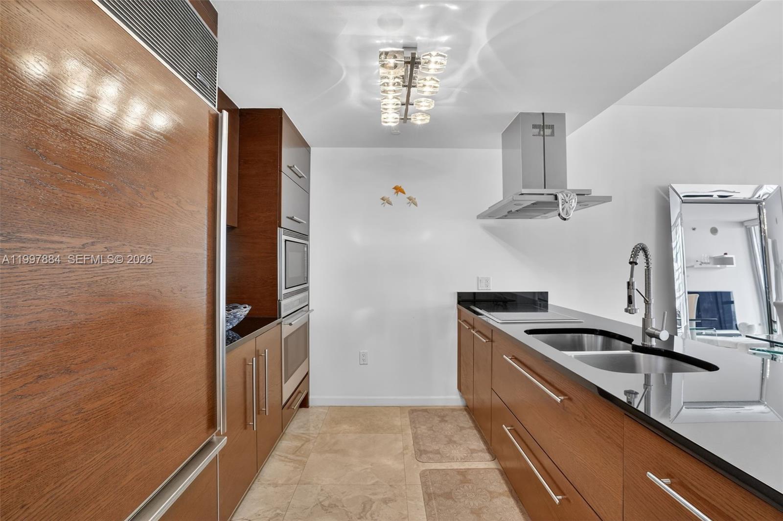 495 Brickell Avenue, Unit 2807 Miami, FL 33131 - Photo 2 of 23 a kitchen with stainless steel appliances granite countertop a sink and a refrigerator