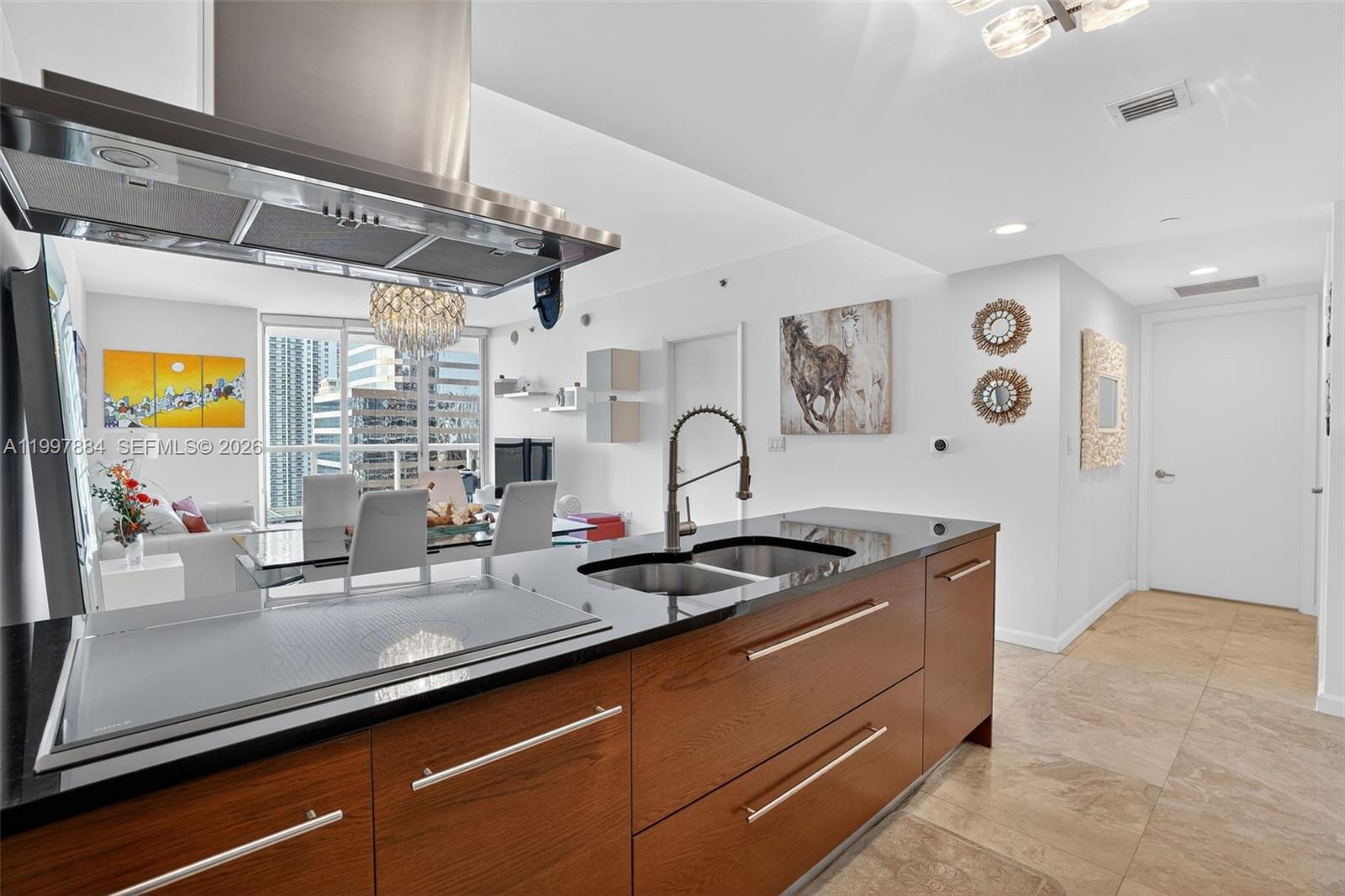 495 Brickell Avenue, Unit 2807 Miami, FL 33131 - Photo 4 of 23 a kitchen with stainless steel appliances granite countertop a sink a stove and a granite counter top