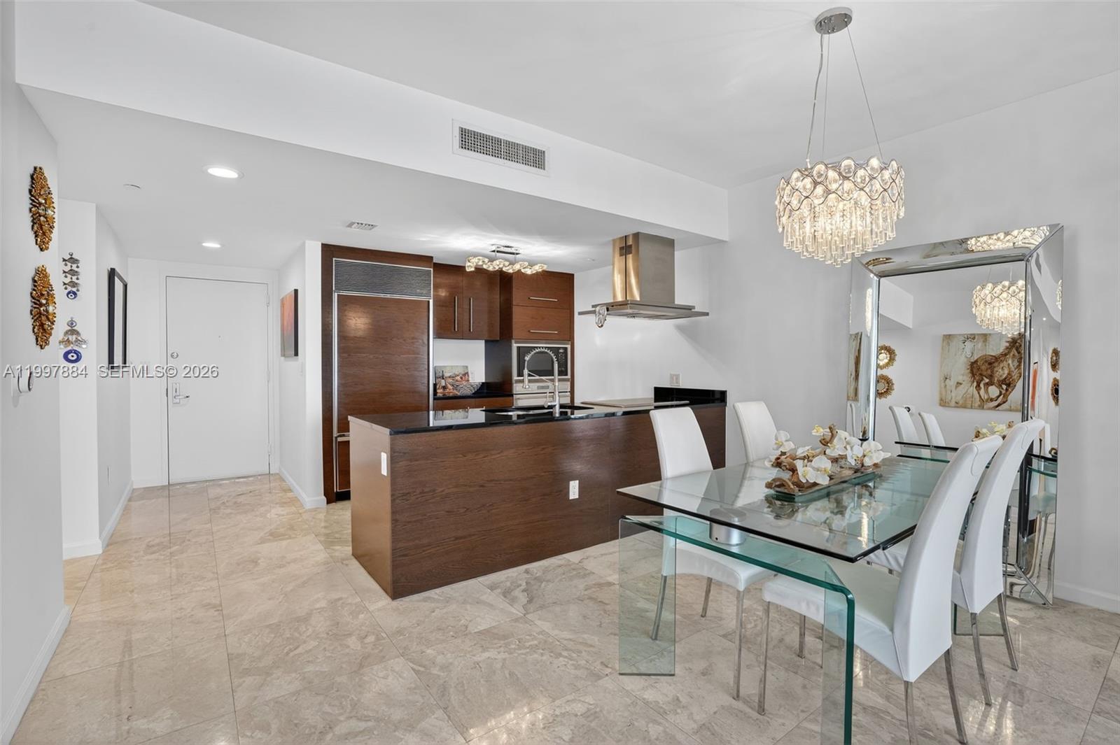 495 Brickell Avenue, Unit 2807 Miami, FL 33131 - Photo 6 of 23 a living room with kitchen island furniture and a chandelier
