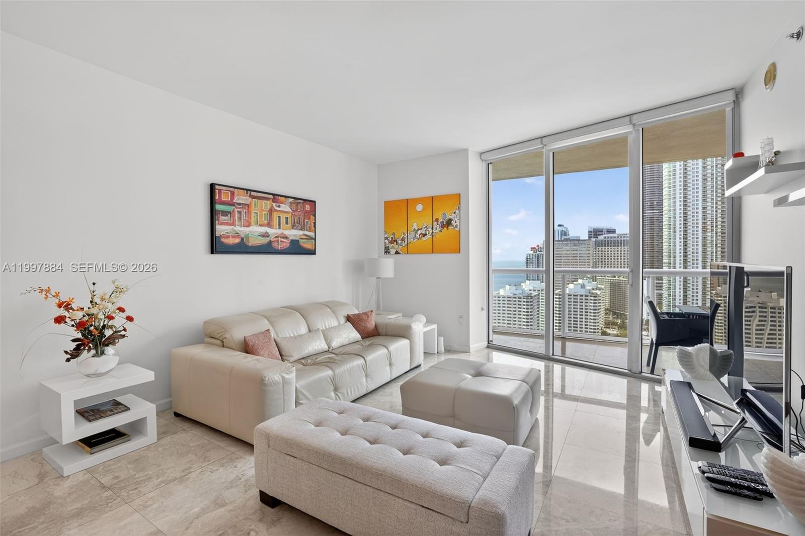 495 Brickell Avenue, Unit 2807 Miami, FL 33131 - Photo 9 of 23 a living room with furniture and a floor to ceiling window