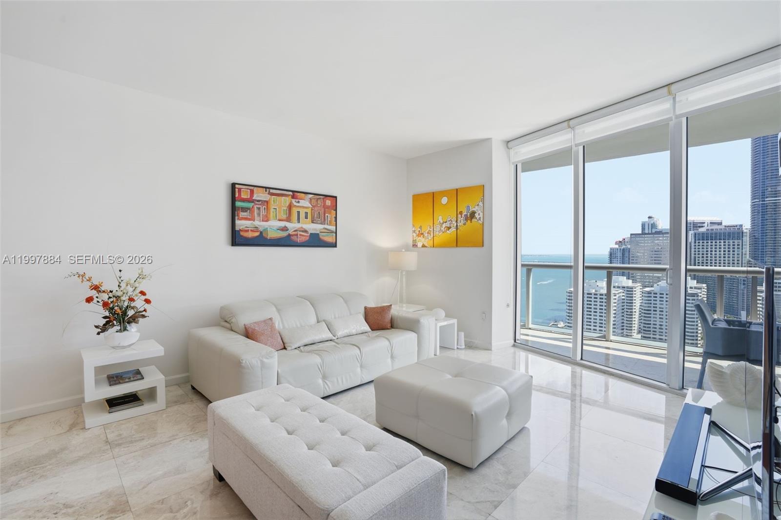 495 Brickell Avenue, Unit 2807 Miami, FL 33131 - Photo 10 of 23 a living room with furniture and a floor to ceiling window