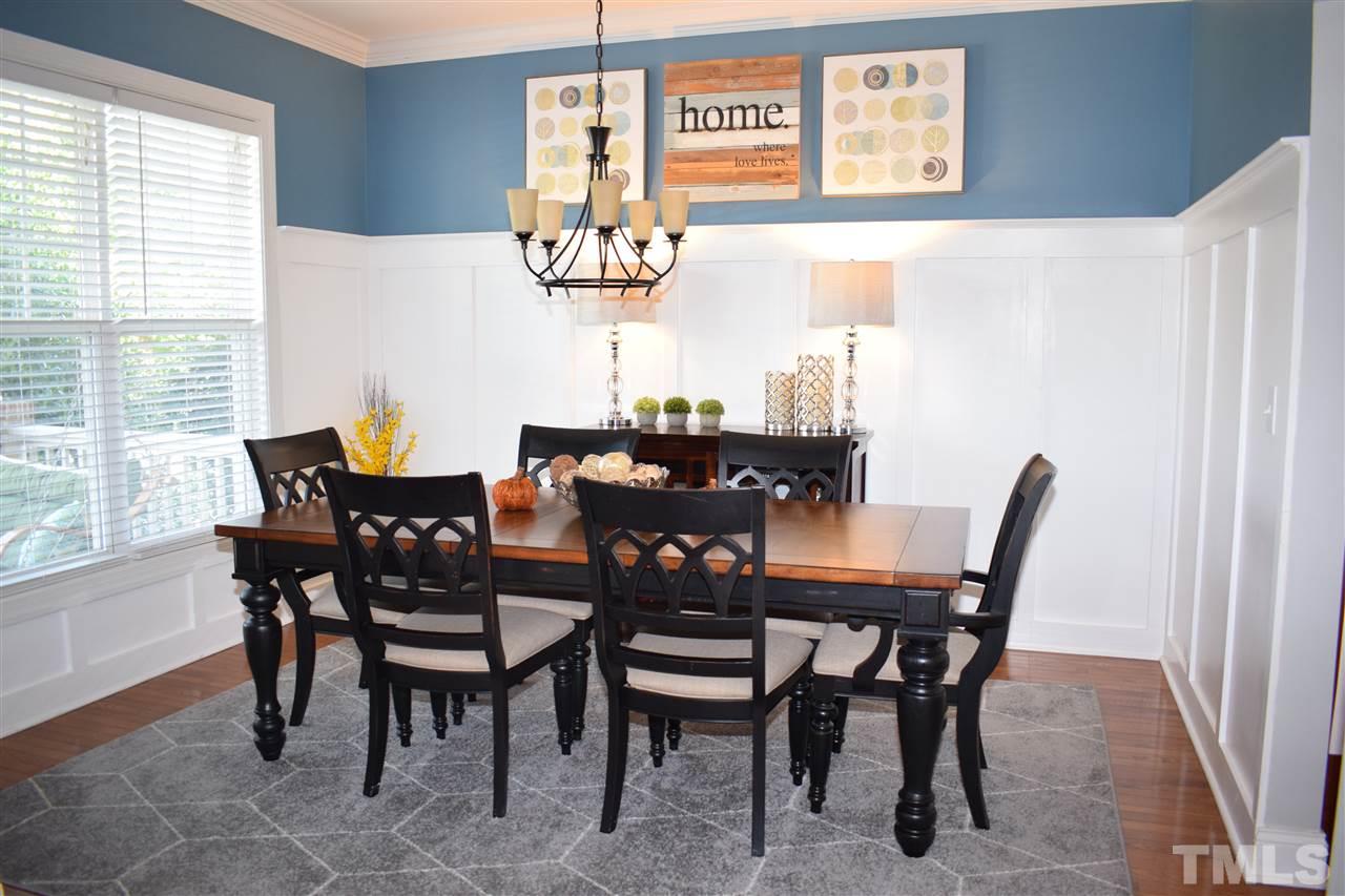10108 2nd Star Court Raleigh, NC 27613 - Photo 3 of 23 Dining room with hardwood floors, 3/4 wainscoting & crown molding.