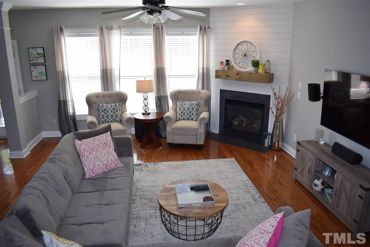 10108 2nd Star Court Raleigh, NC 27613 - Photo 4 of 23 Open family room with shiplap surround gas log fireplace, hardwoods, recessed lighting & ceiling fan.