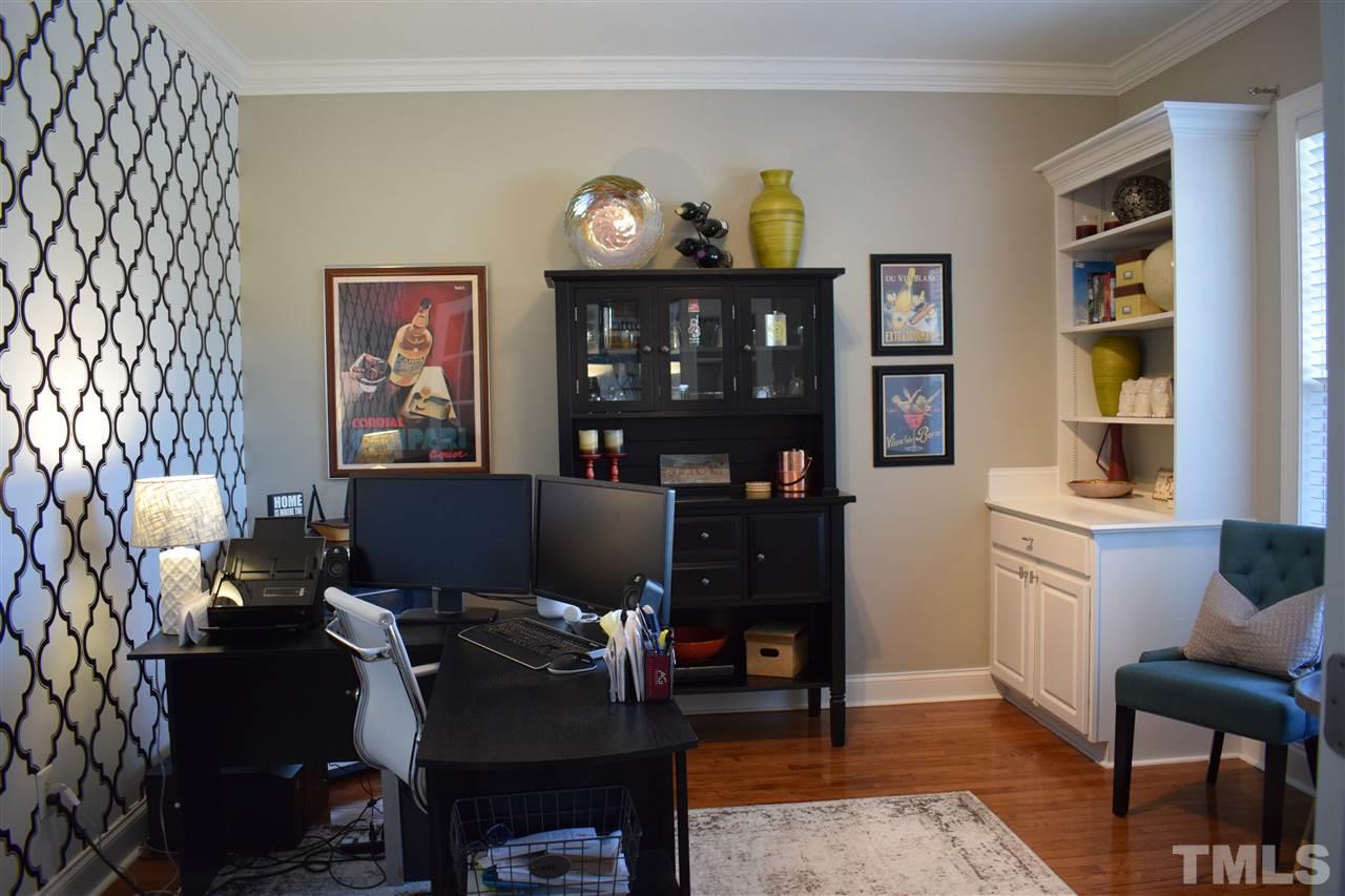 10108 2nd Star Court Raleigh, NC 27613 - Photo 8 of 23 Office or formal living room with french doors, built-ins, hardwood floors & crown molding.