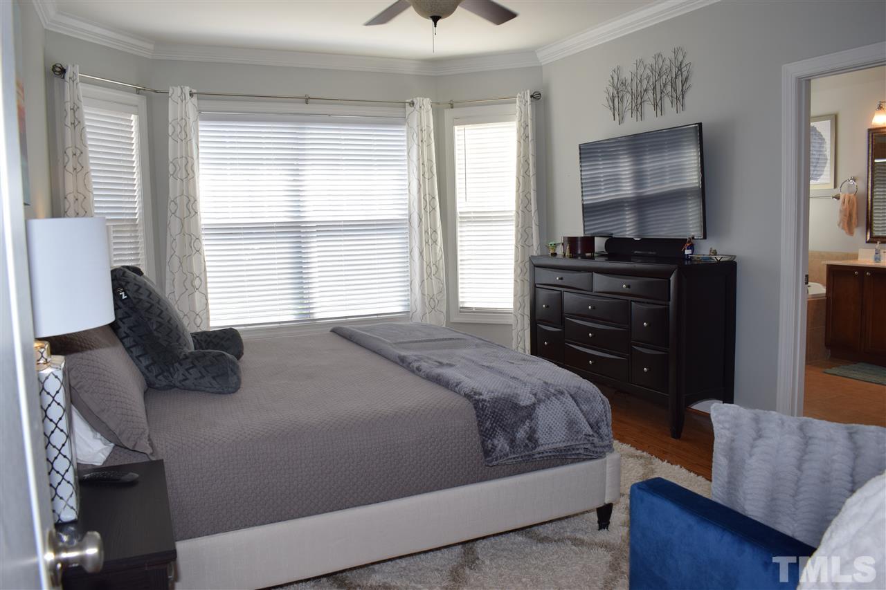10108 2nd Star Court Raleigh, NC 27613 - Photo 9 of 23 First floor master bedroom with hardwood floors, bay window & ceiling fan. Master bath has garden tub/ separate shower & dual sinks. Walk-in closet with custom shelving.